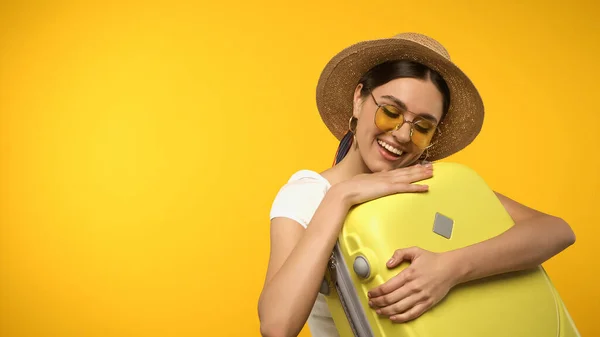 Young Tourist Sun Hat Sunglasses Holding Suitcase Isolated Yellow — Stockfoto