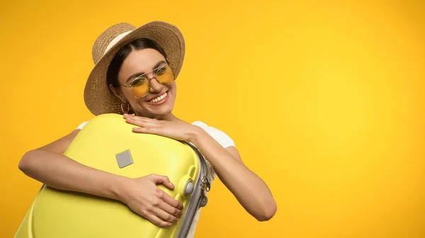 Young Woman Sunglasses Hugging Suitcase Isolated Yellow — Zdjęcie stockowe