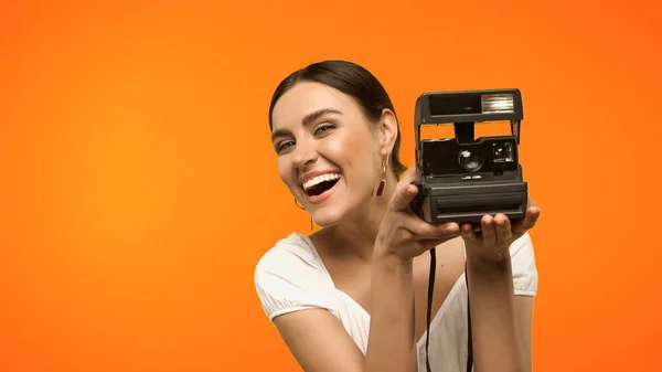 Positive Woman Holding Vintage Camera Isolated Orange — 图库照片