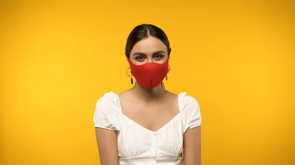 Young Woman Protective Mask Looking Camera Isolated Yellow — стоковое фото