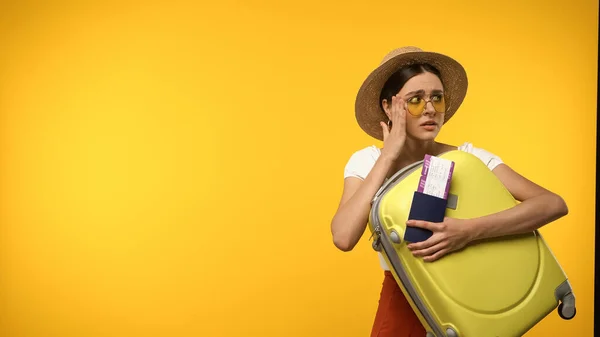 Worried Traveler Sun Hat Holding Passport Suitcase Isolated Yellow — Stock Photo, Image