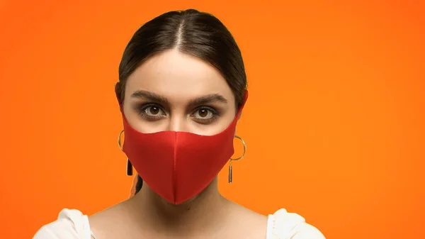 Young Brunette Woman Blouse Protective Mask Looking Camera Isolated Orange — стоковое фото