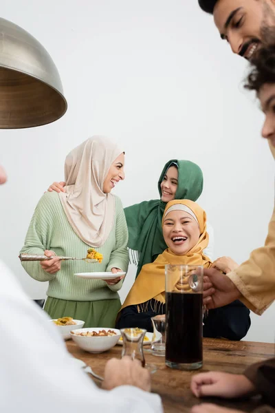 stock image Cheerful multiethnic muslim family talking near food at home 