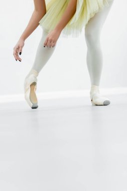 cropped view of ballerina in pointe shoes dancing during repetition clipart