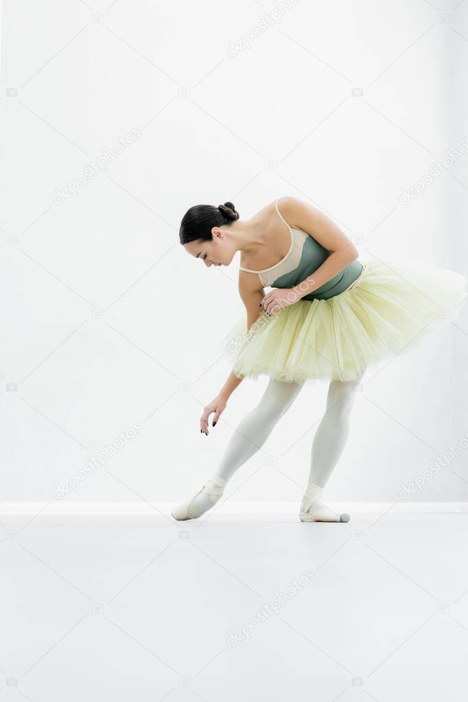 young ballerina practicing choreographic elements during repetition