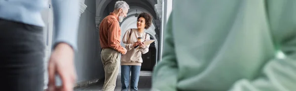 Mature Teacher Talking African American Student Coffee Notebook University Corridor — Stock Photo, Image