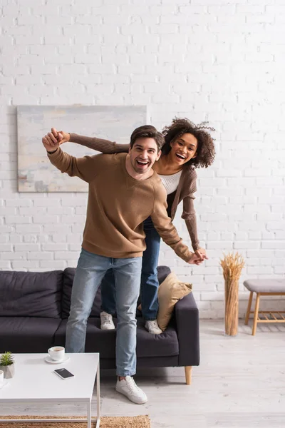 Positive Interracial Couple Holding Hands Looking Camera Home — Stock Photo, Image