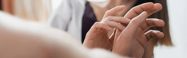 cropped view of young couple sensually touching hands at home, banner