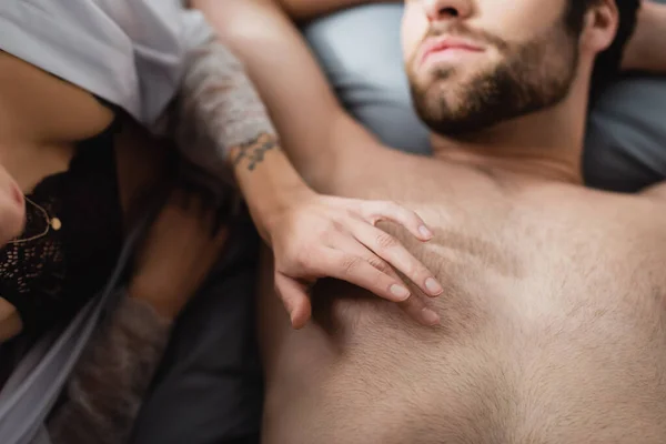 Partial View Blurred Tattooed Woman Lying Shirtless Man Bedroom — Stock Photo, Image