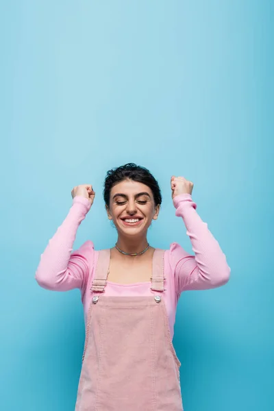 Excited Woman Closed Eyes Showing Win Gesture Isolated Blue — Stock Photo, Image