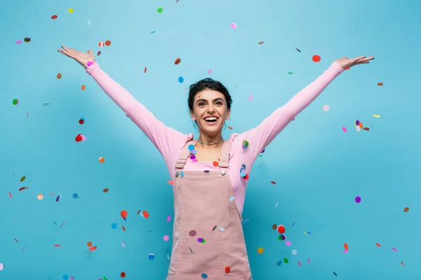 Excited Woman Pastel Clothes Smiling Falling Confetti Blue Background — Stock Photo, Image