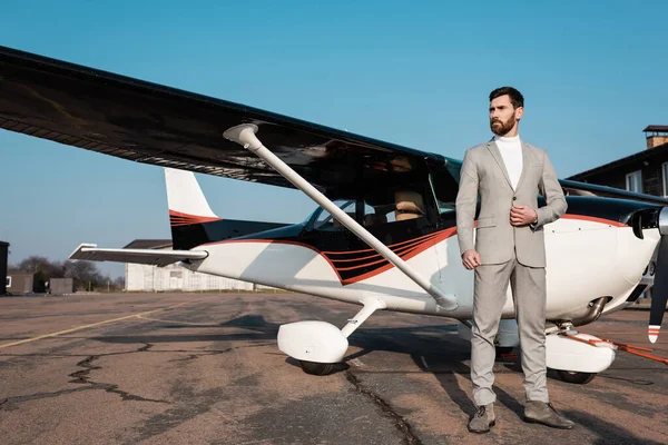 Full Length Confident Businessman Suit Standing Modern Helicopter Adjusting Blazer — Stock Photo, Image