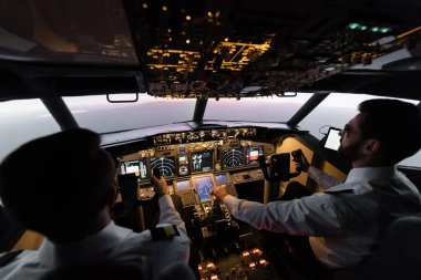high angle view of professionals piloting airplane in evening during sunset  clipart