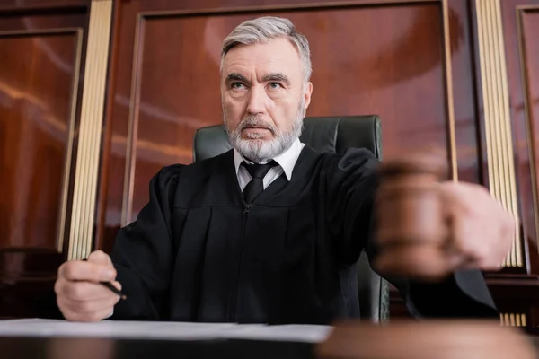 Senior Judge Mantle Holding Blurred Gavel While Sentencing Court — Stock Photo, Image