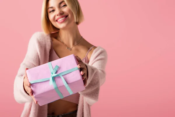 Blurred Cheerful Young Woman Cardigan Holding Wrapped Gift Box Isolated — Stock Photo, Image