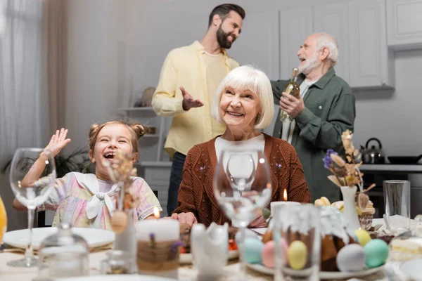 Excited Girl Waving Hand Smiling Granny Festive Dinner Home — Stock Photo, Image