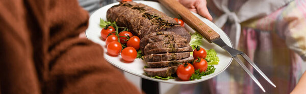 selective focus of fried meat with fresh vegetables near cropped family, banner