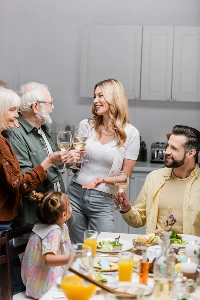 Cheerful Family Clinking Wine Glasses Easter Dinner Kitchen — Stock Photo, Image