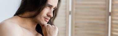 pensive shirtless man with long hair looking away, banner clipart
