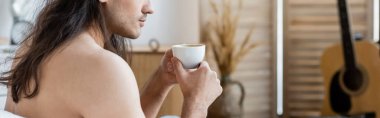 cropped view of shirtless man with long hair holding cup of coffee, banner clipart
