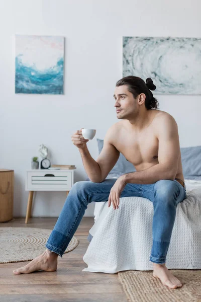 Shirtless Man Long Hair Holding Cup Coffee While Sitting Bedroom — Stock Photo, Image