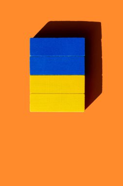 bright blue and yellow blocks on orange background, top view, ukrainian concept clipart