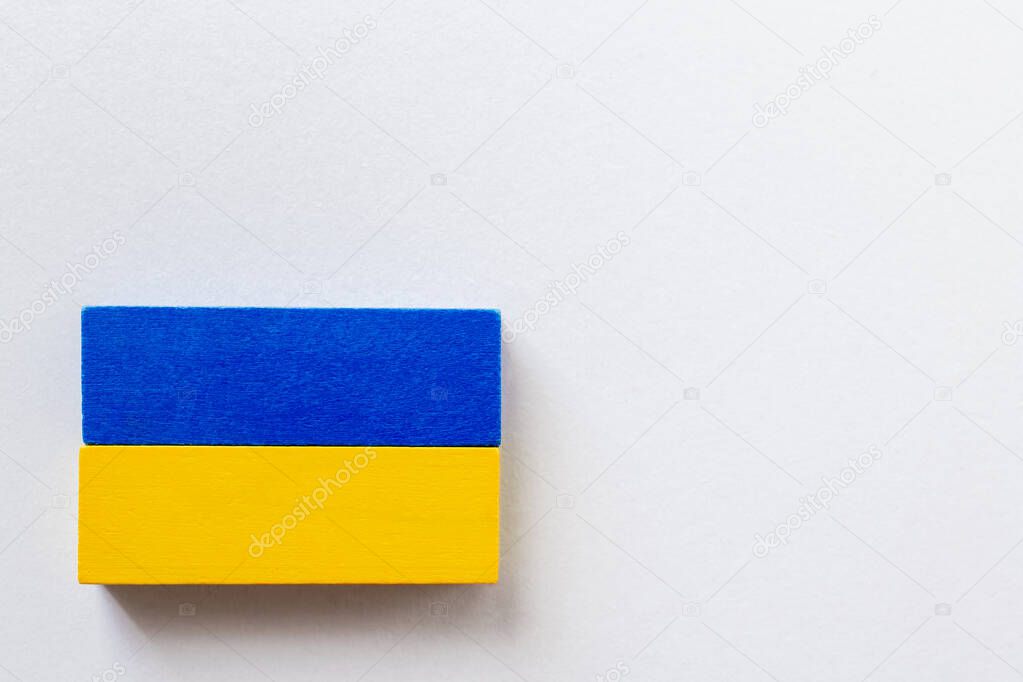 top view of blue and yellow blocks on white background, ukrainian concept