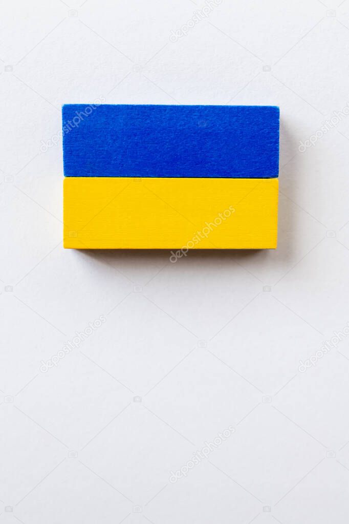 top view of blue and yellow blocks on white background with copy space, ukrainian concept