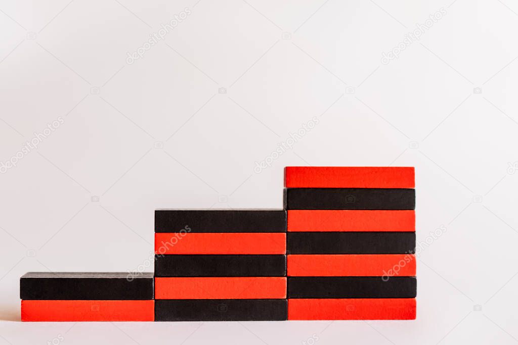 red and black blocks stacked in stairs shape on white background