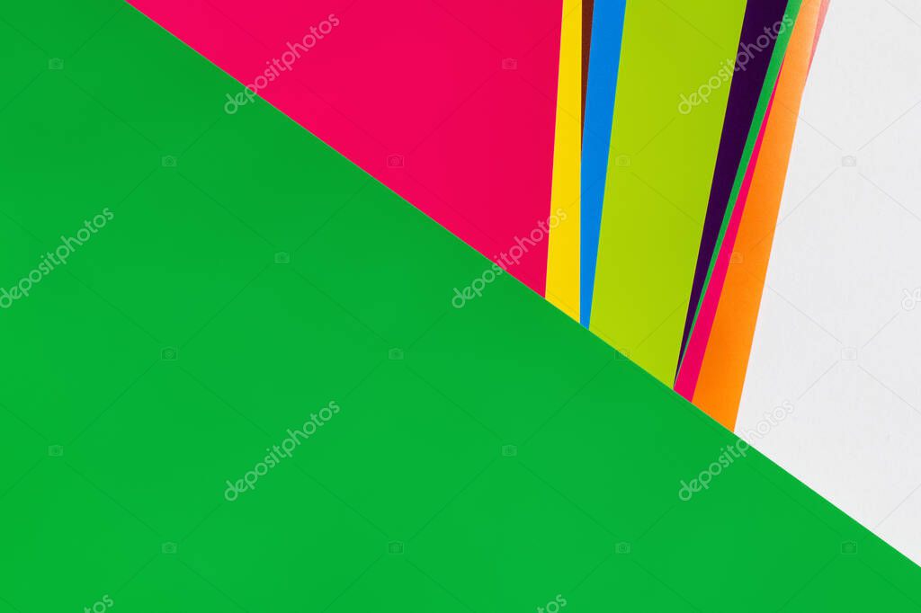 multicolored background with bright stripes and green copy space