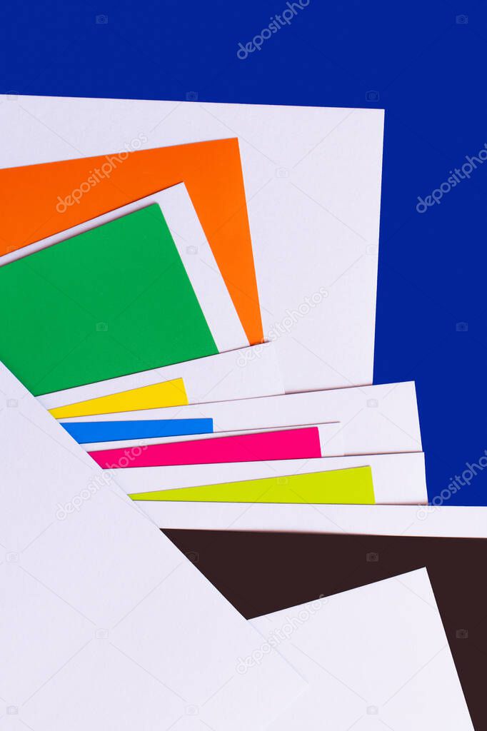 abstract geometric background with multicolored paper sheets on blue