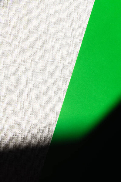 green and white textured background with black shadow