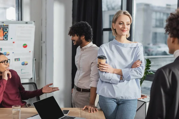 Positive Businesswoman Holding Takeaway Drink Blurred African American Colleague Office — Stock Photo, Image