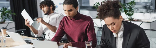 African american business people working near indian colleague in office, banner