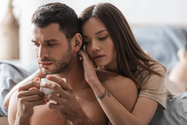 Pretty Brunette Woman Touching Sexy Boyfriend Cup Coffee Bedroom — Stock Photo, Image