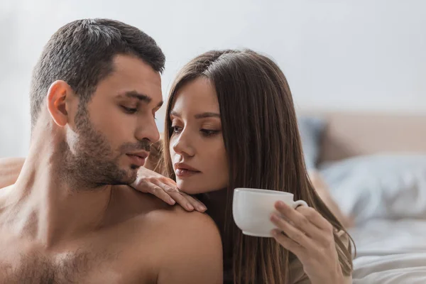 Young Brunette Woman Holding Cup Coffee Muscular Boyfriend Bedroom — Stock Photo, Image