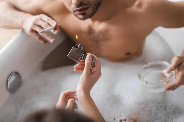 Overhead View Woman Holding Lighter Blurred Boyfriend Cigarette Ashtray Bathtub — Stock Photo, Image