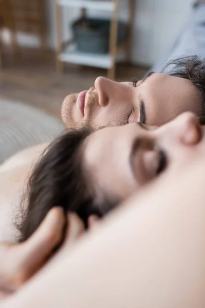 Close View Young Man Closed Eyes Lying Blurred Girlfriend — Stok Foto