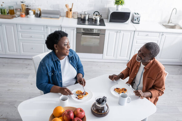 high angle view of happy and senior african american couple having breakfast 
