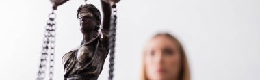 selective focus of themis statue near prosecutor on blurred foreground, banner clipart