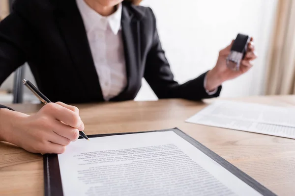 Partial View Notary Signing Contract Holding Stamper Blurred Background — Foto de Stock