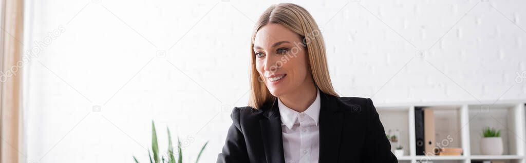 smiling blonde lawyer working in office, banner