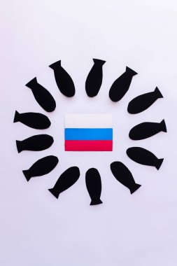 Top view of russian flag in frame from paper bombs on white background  clipart