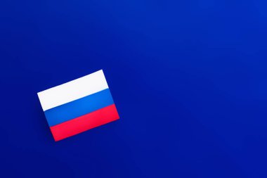 Top view of russian flag on blue background  clipart