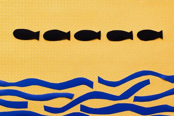 Top view carton sea and paper bombs on textured yellow background, war in ukraine concept 