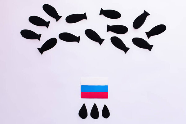 Top view of paper bombs and drops near russian flag on white background, war in ukraine concept 