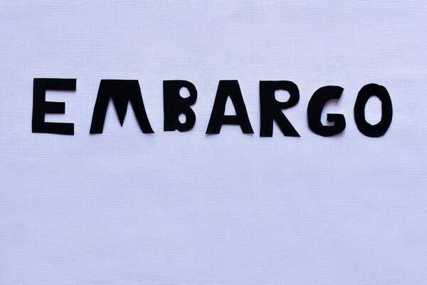 Top view of embargo lettering on white background 
