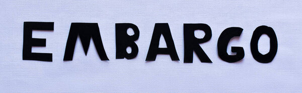 Top view of embargo lettering on white background, banner 