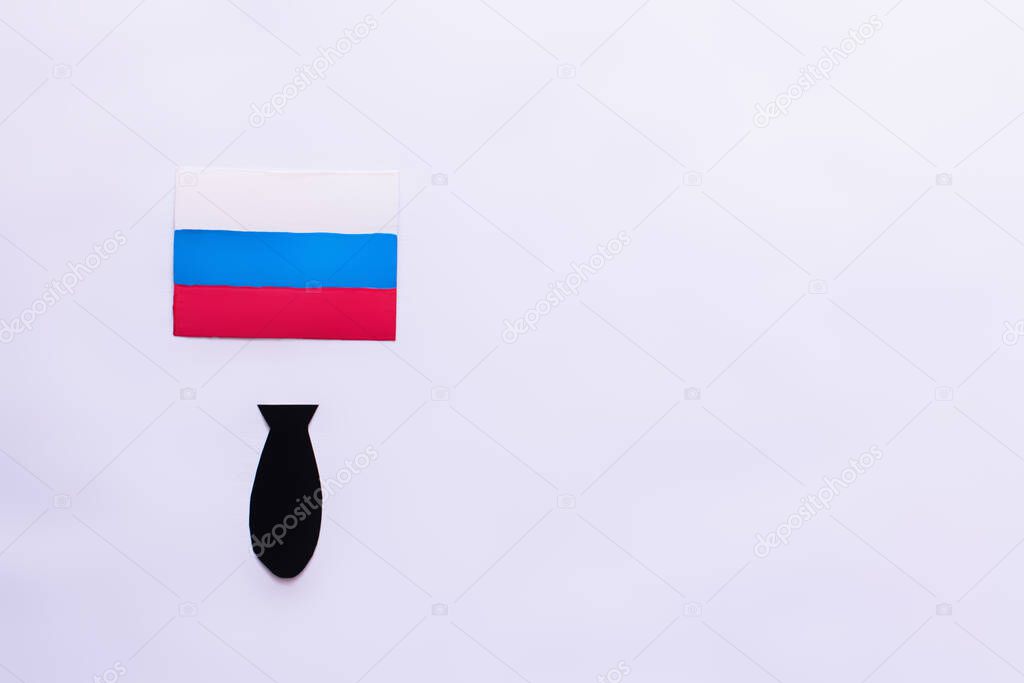 Top view of russian flag and paper bomb on white background with copy space, war in ukraine concept 