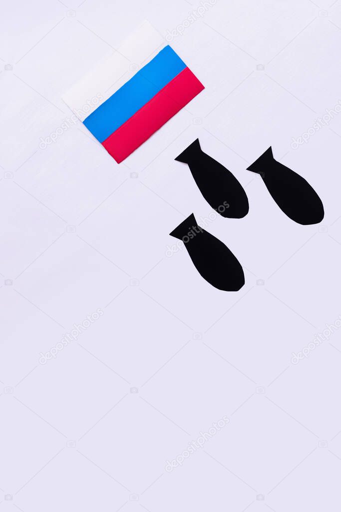 Top view of paper bombs under russian flag on white background, war in ukraine concept 